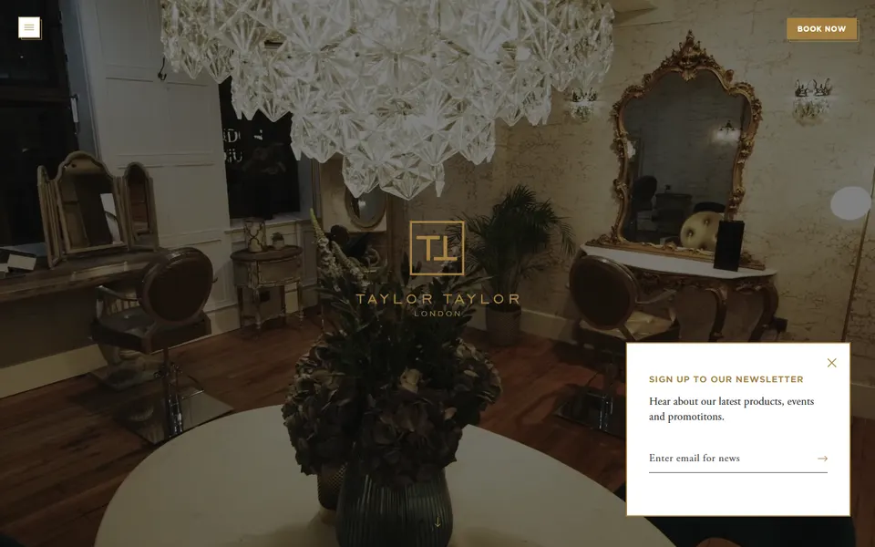 Screenshot Taylor Taylor London: donkere interieurhero met klein gecentreerd logo